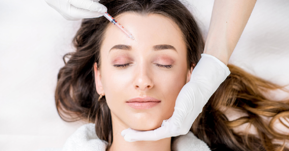 Woman receiving forehead injection while lying down, representing Neuromodulators in Richmond, KY for non-surgical wrinkle reduction and facial rejuvenation.